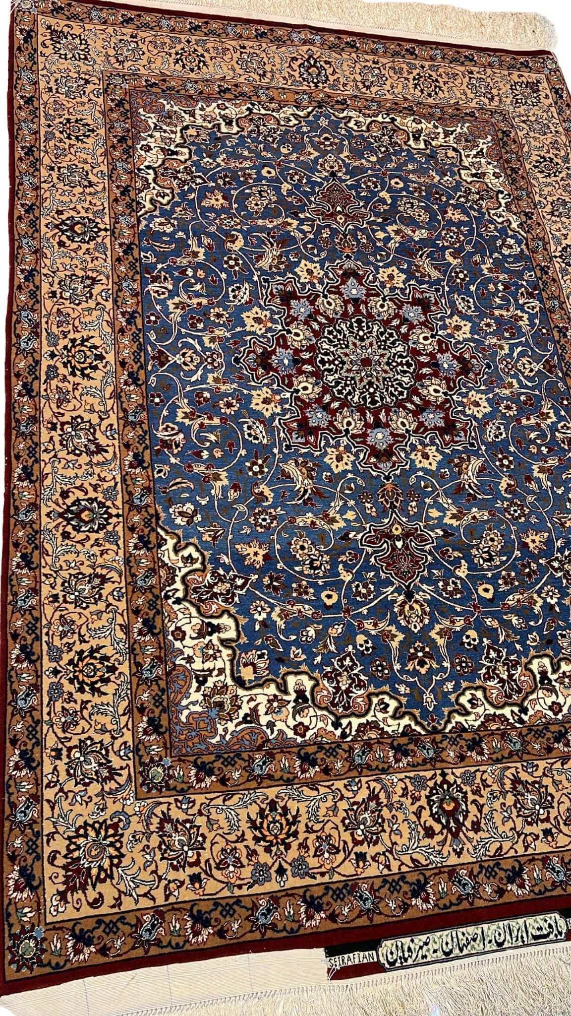 "Side view of a luxurious Seirafian Persian rug, emphasizing the fine handwoven silk and wool material and intricate patterning, crafted in Isfahan by Master Hassan Seirafian."